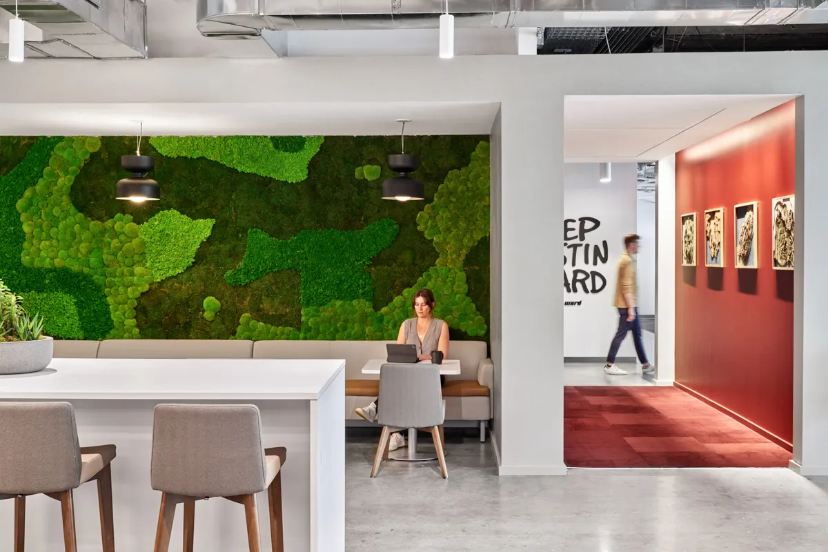 Office caffeteria with acoustic greenery architectural design on walls.